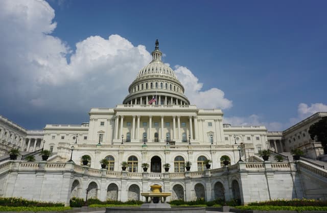 US Capitol Building with dark clouds in the sky. 