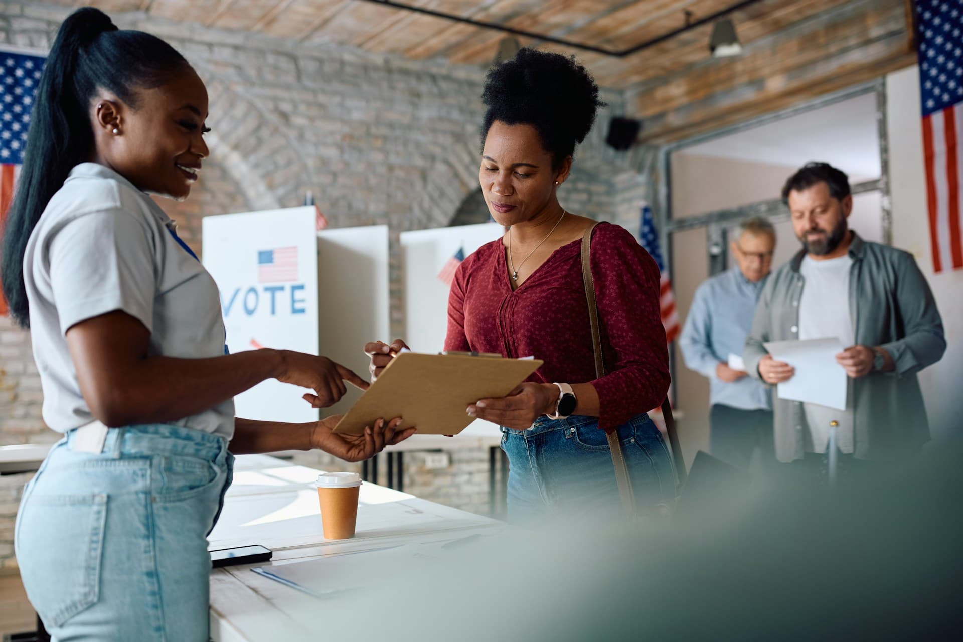Image of voters at a polling location.