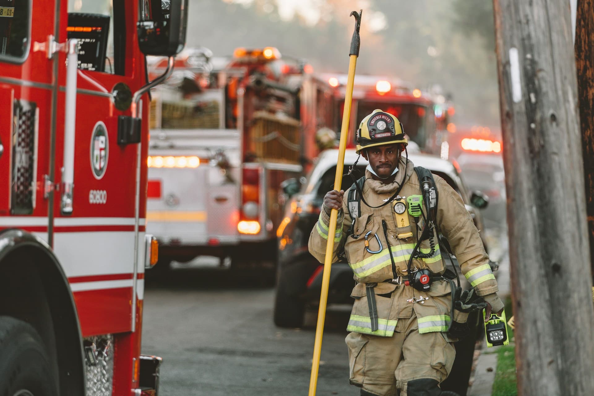 LA firefighter walking near fire truck.