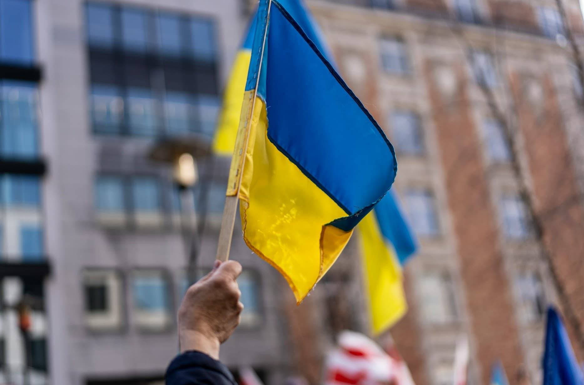 Protester holding up Ukraine flag. 
