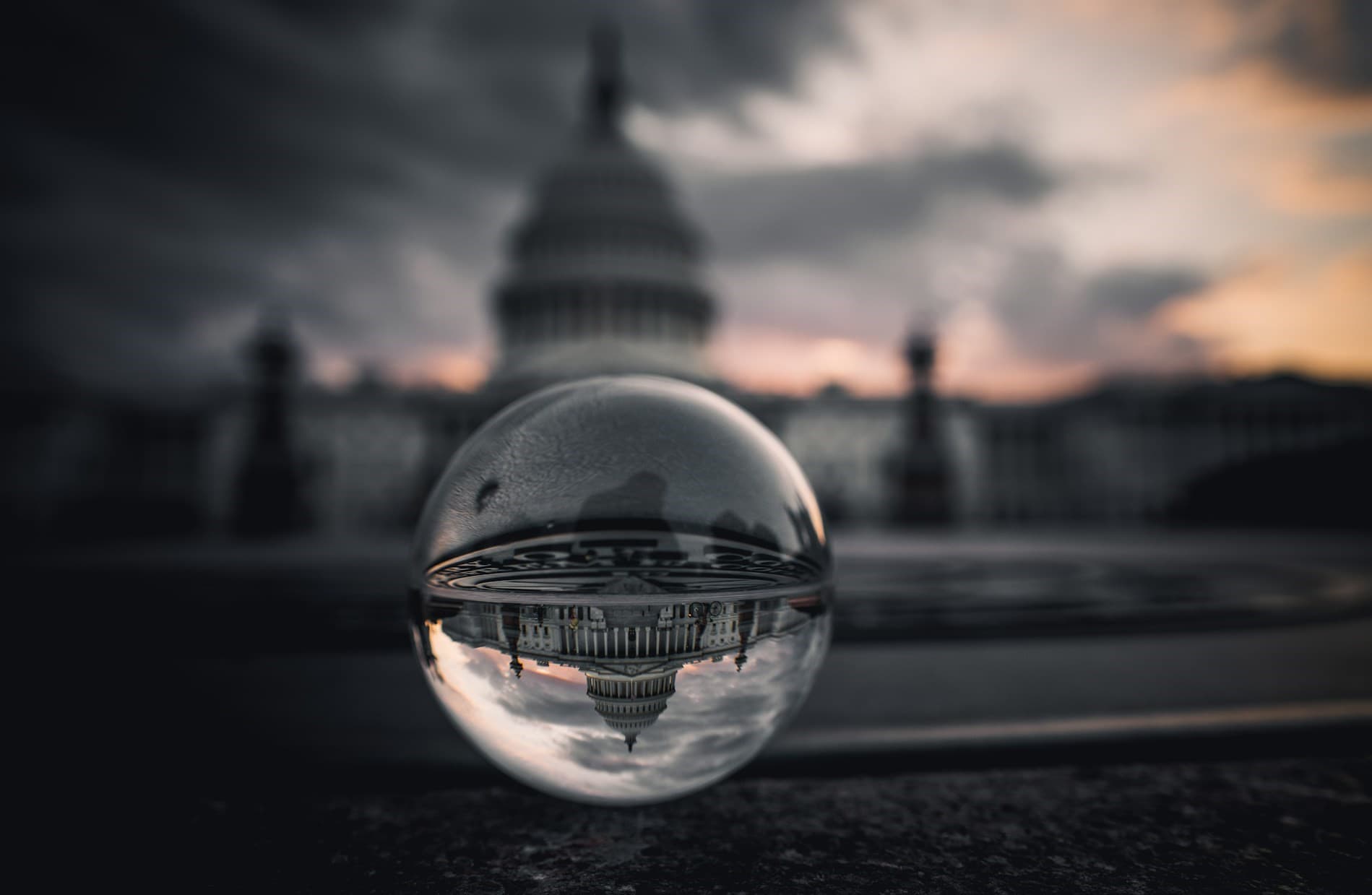 US capitol building shown upside down in small orb. 