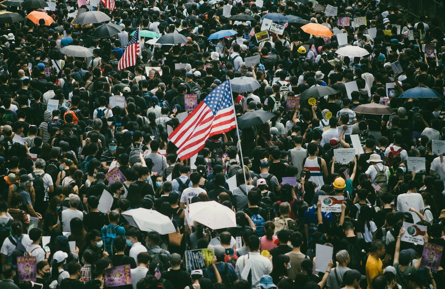 Crowd of people with an American flag in the center. 