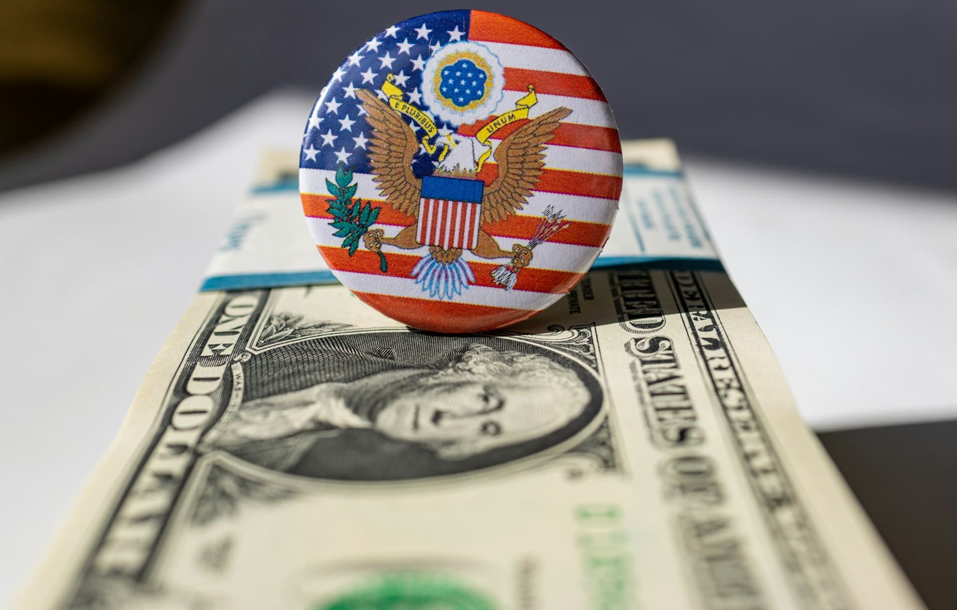 American government symbol on top of a stack of money. 