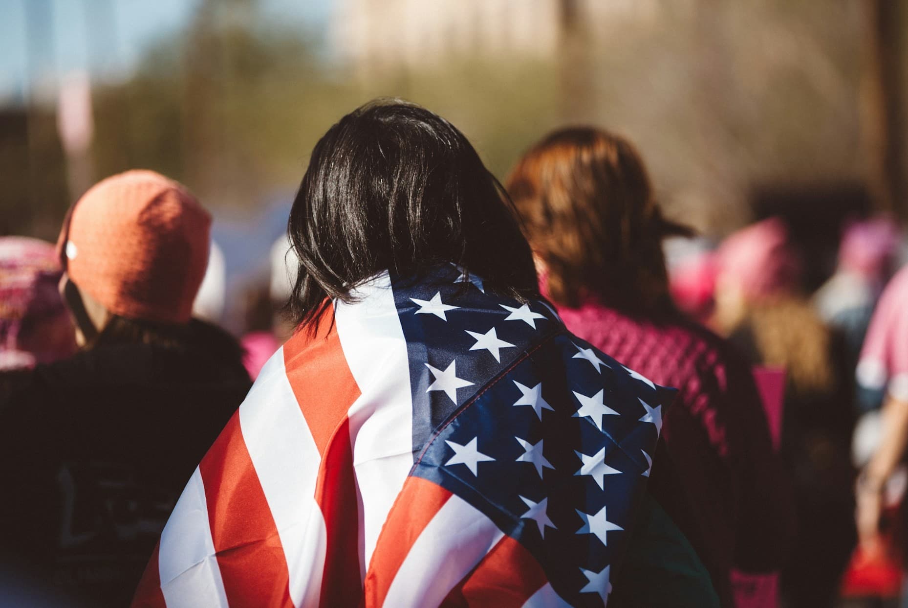 American flag on the back of a person at a gathering.