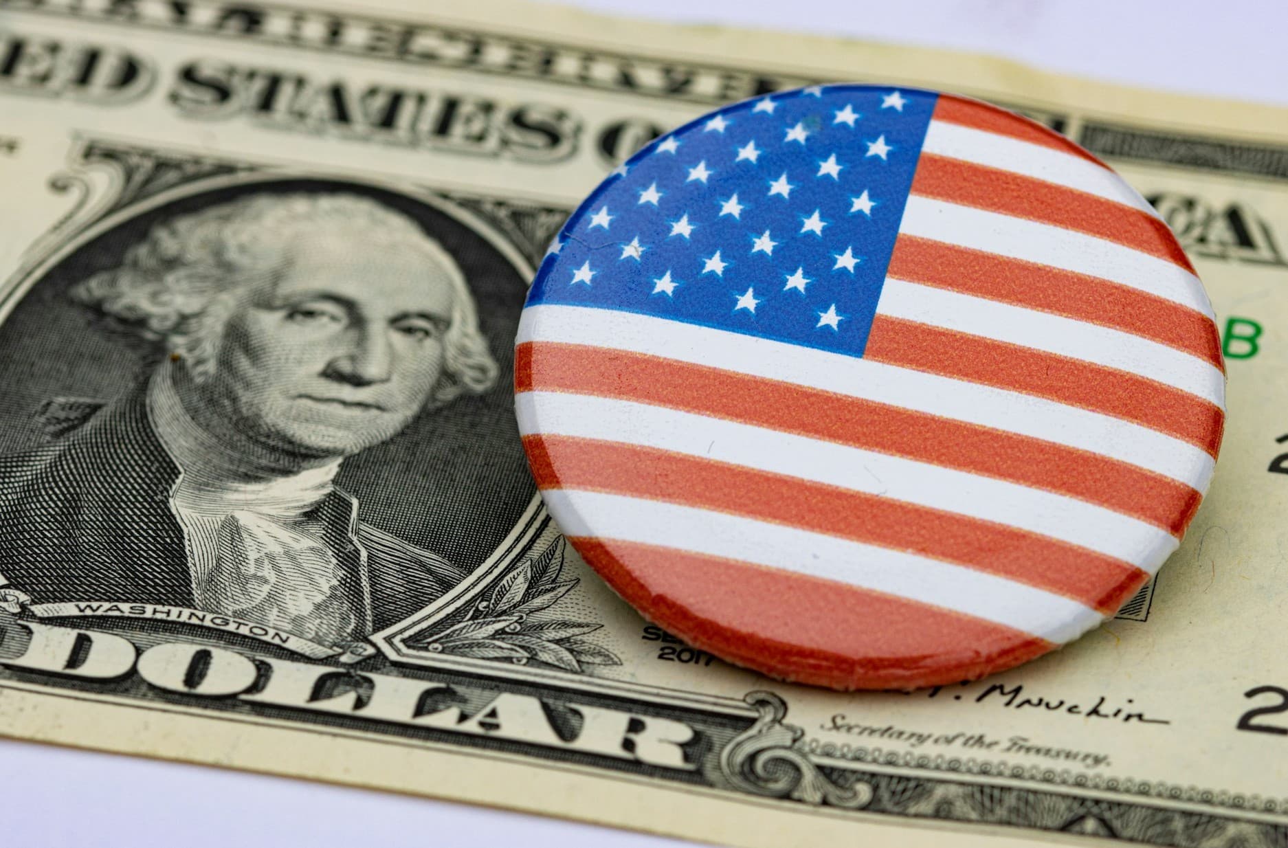 American flag button on dollar bill.