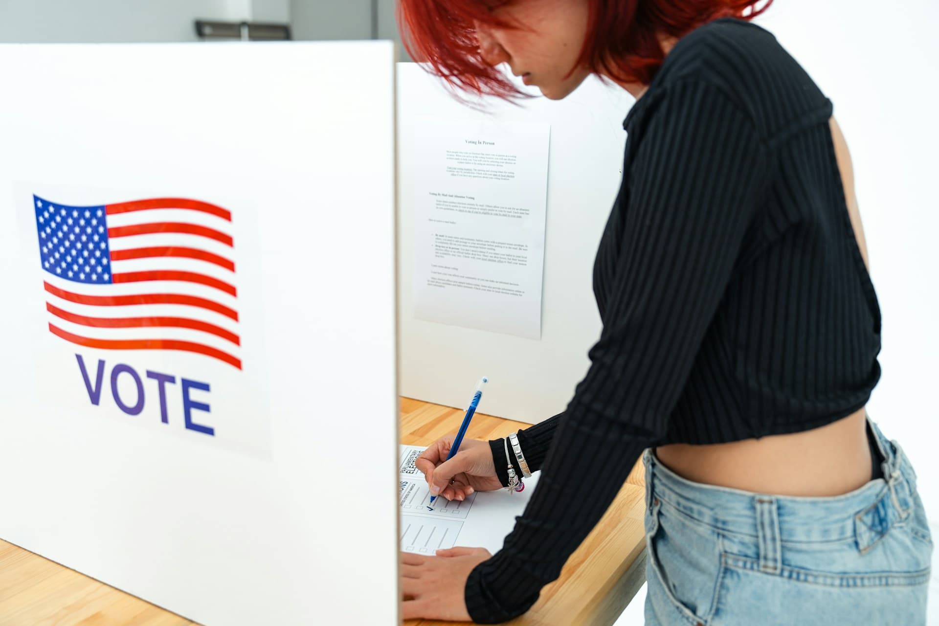 A young woman voting. 