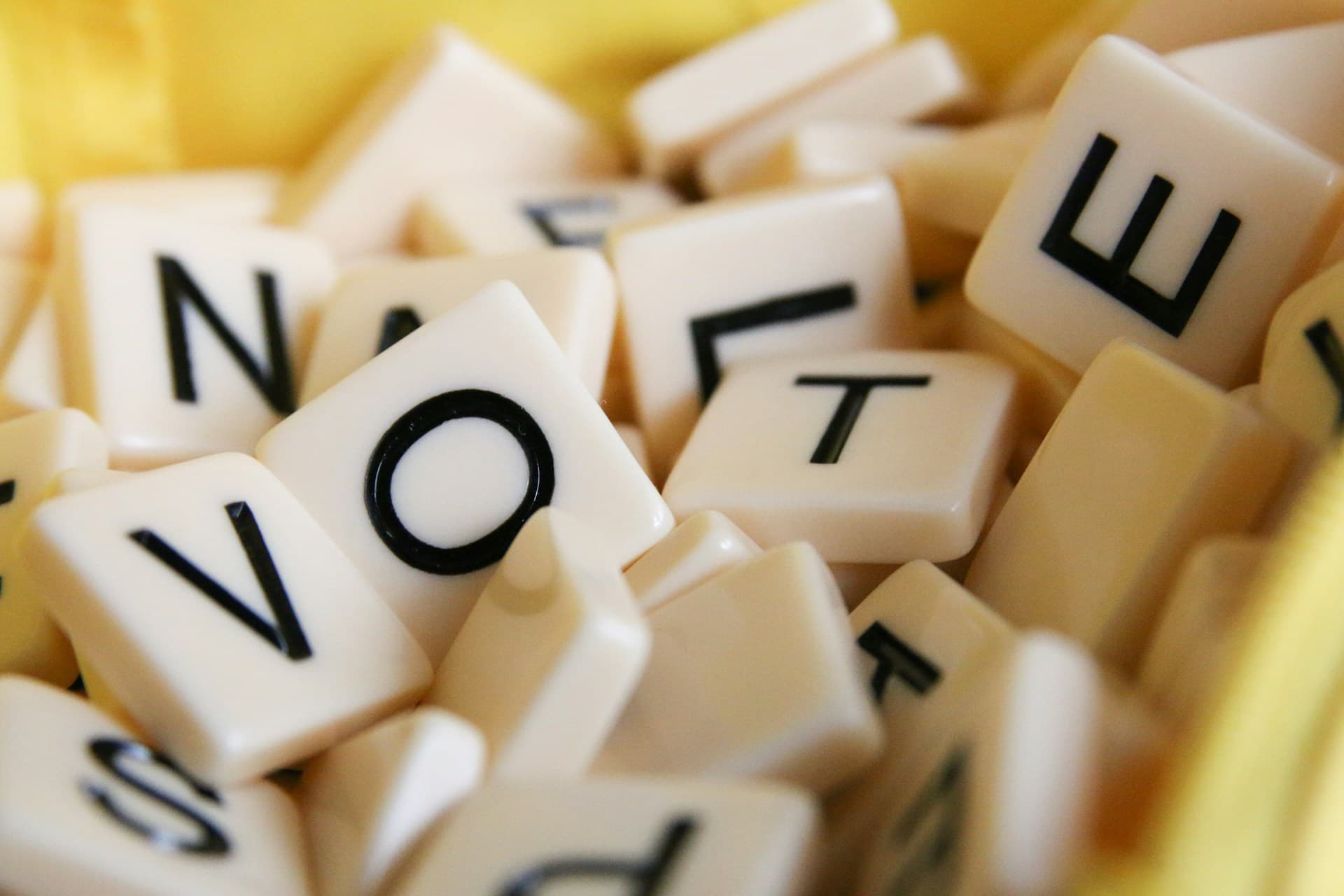 Scrabble pieces that spell out vote. 