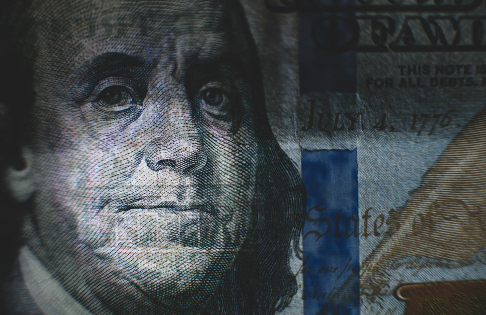 Shadow over Ben Franklin's portrait on the 100 dollar bill. 