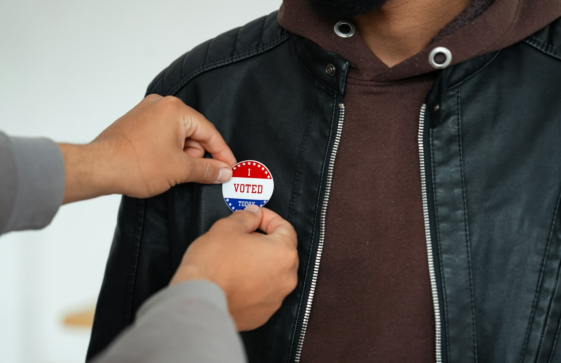 I voted sticker being put on someone. 