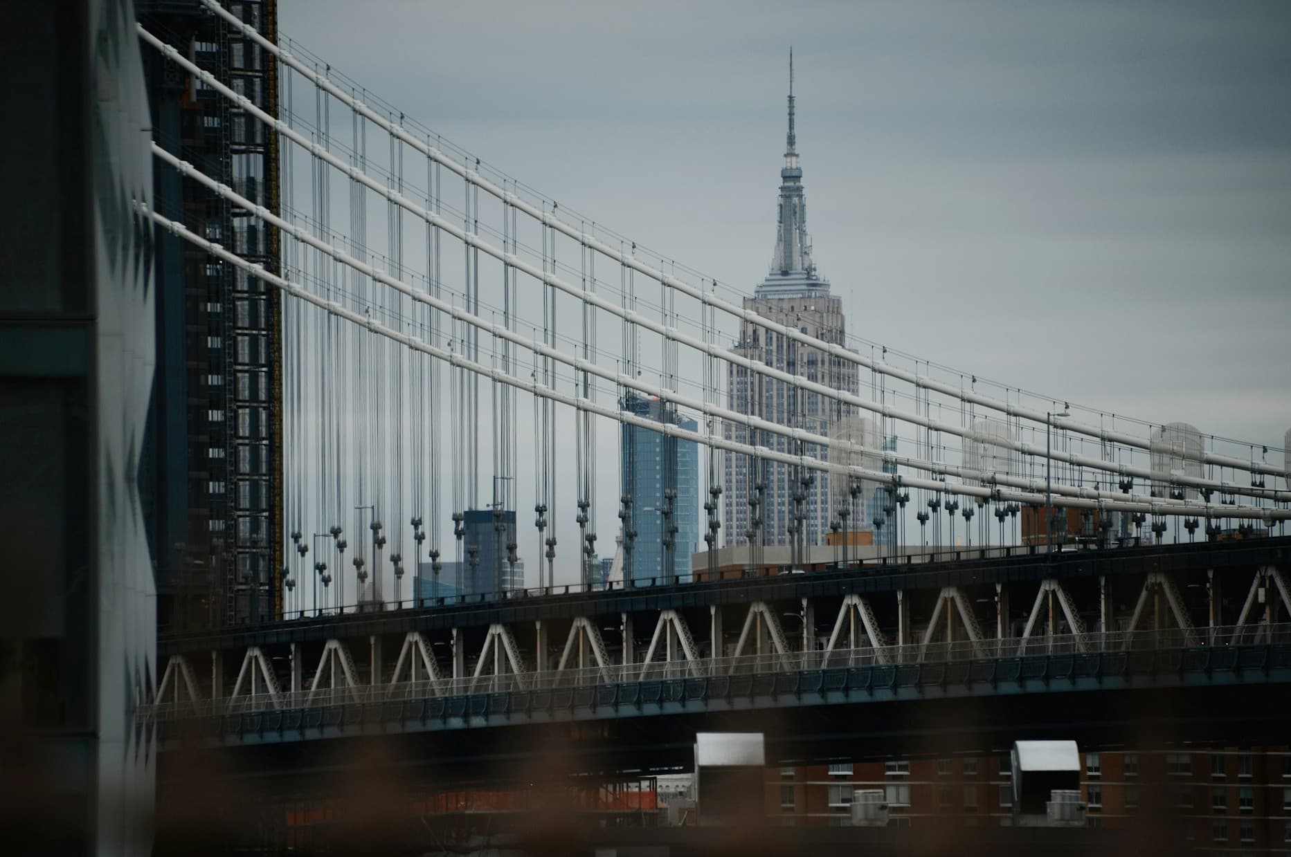 Picture of skyscraper in New York behind a bridge.