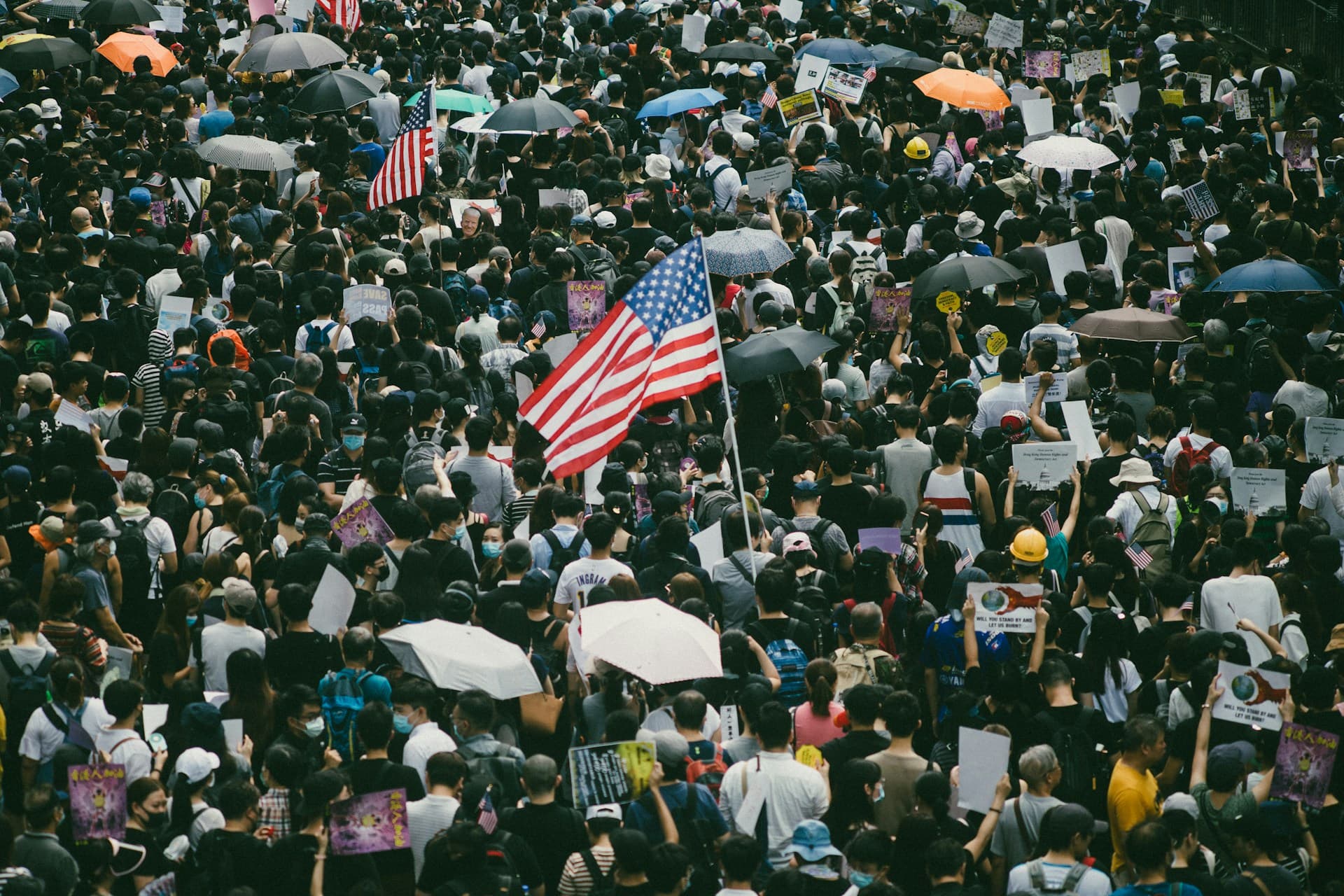Crowd of people with an American flag in the center.
