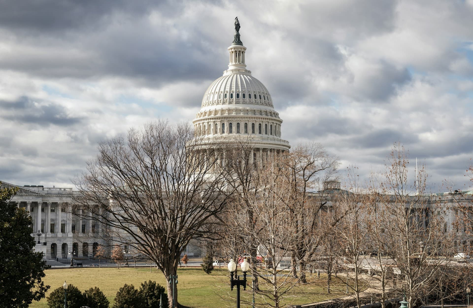 The US Capitol Building with dark clouds over it. 