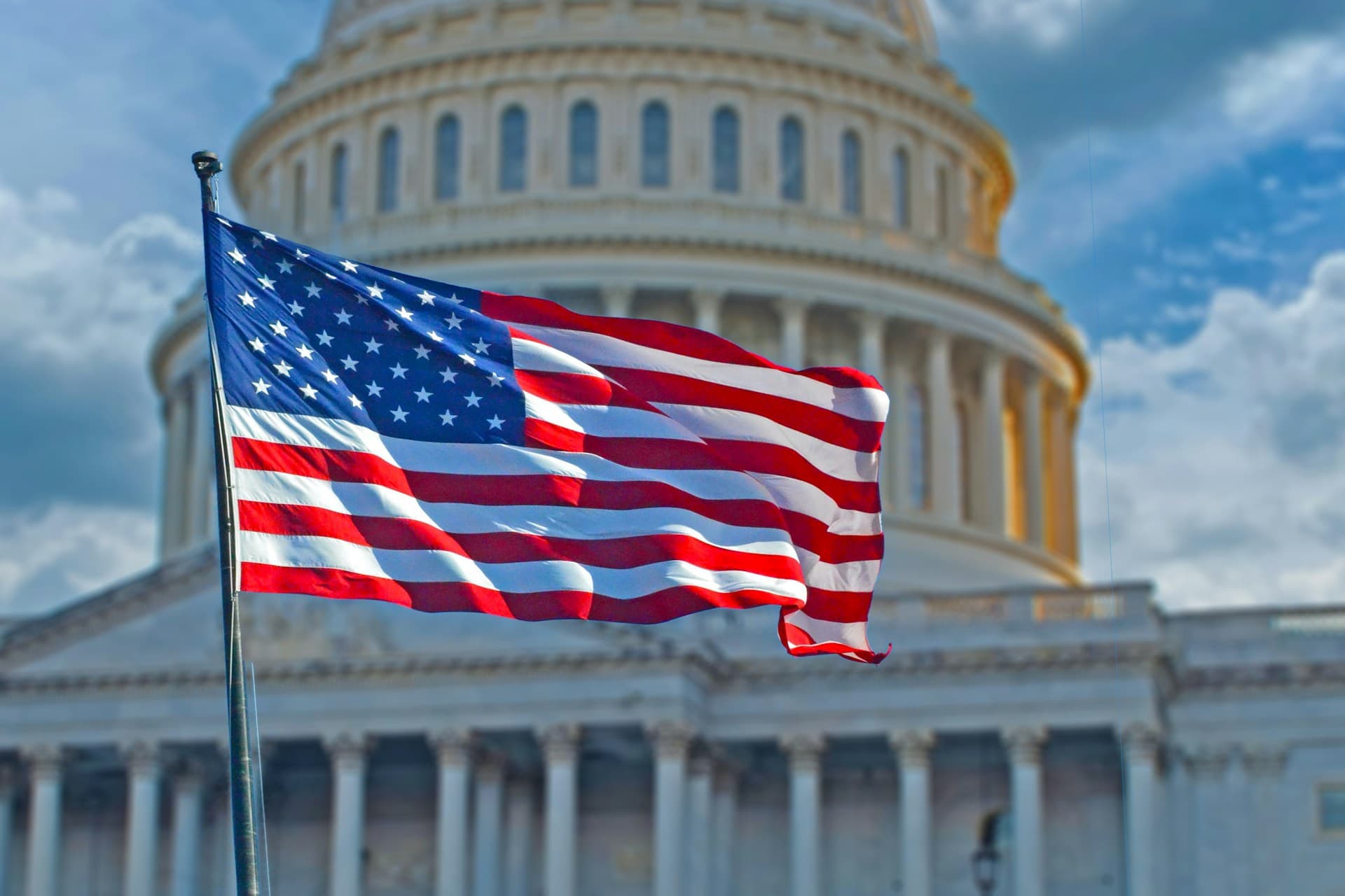 US Capitol Building with American Flags in front. 