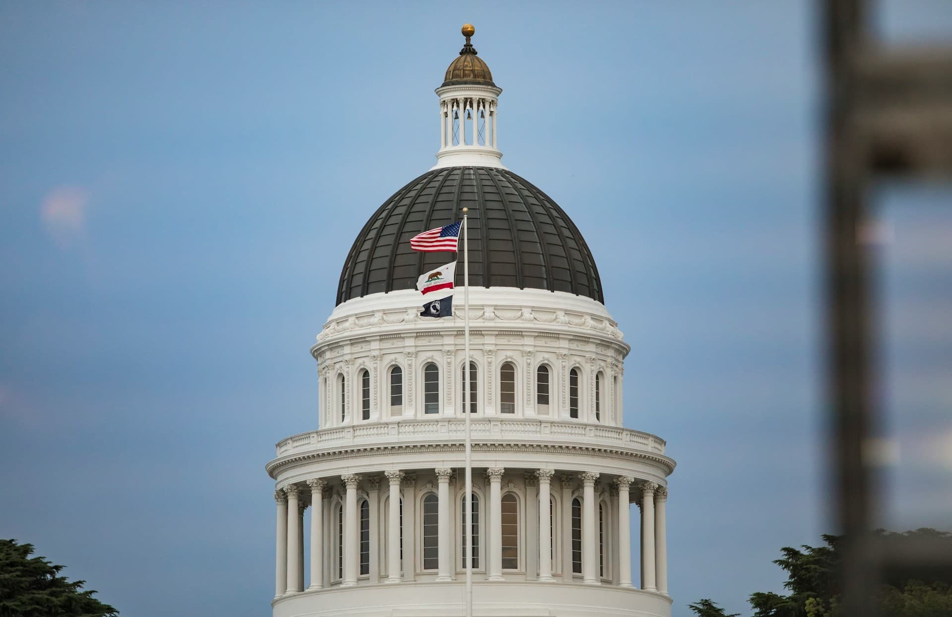 CA capitol building dome with flags. 