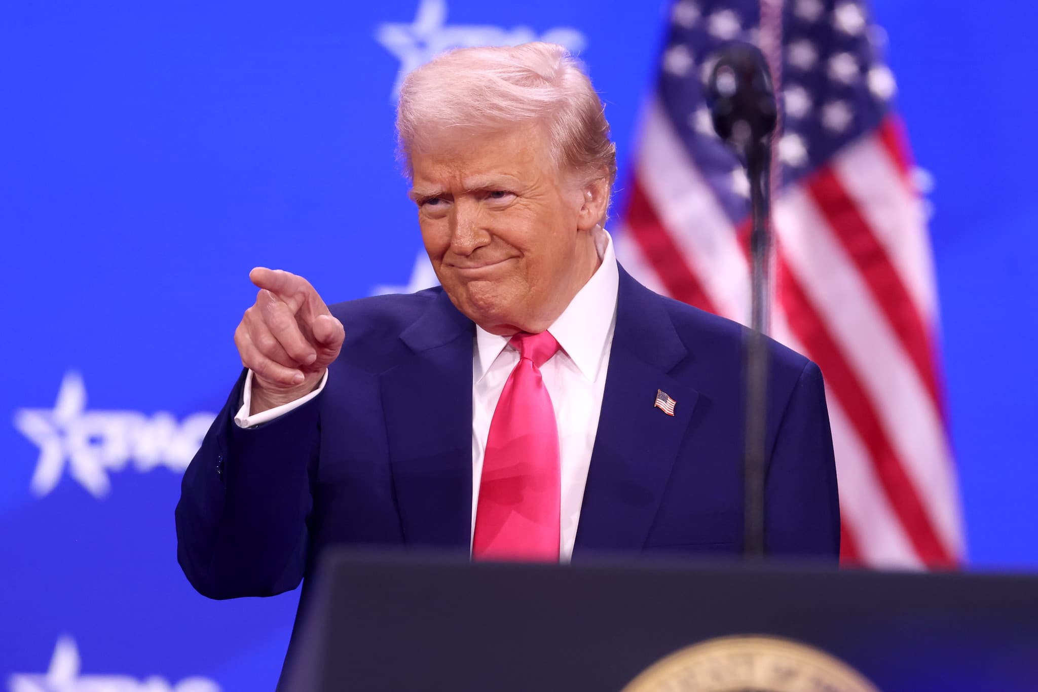 Donald Trump pointing into audience.
