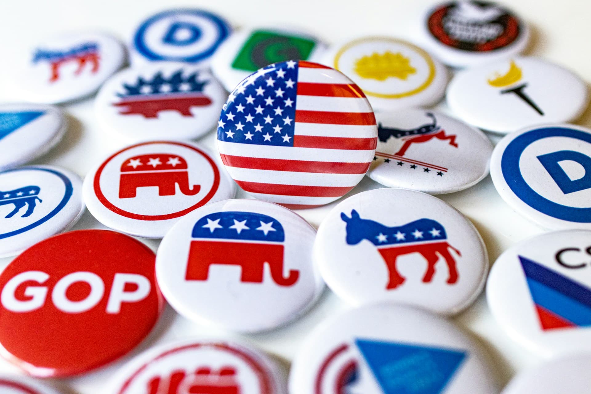 buttons with party symbols on them and an american flag button in the center. 